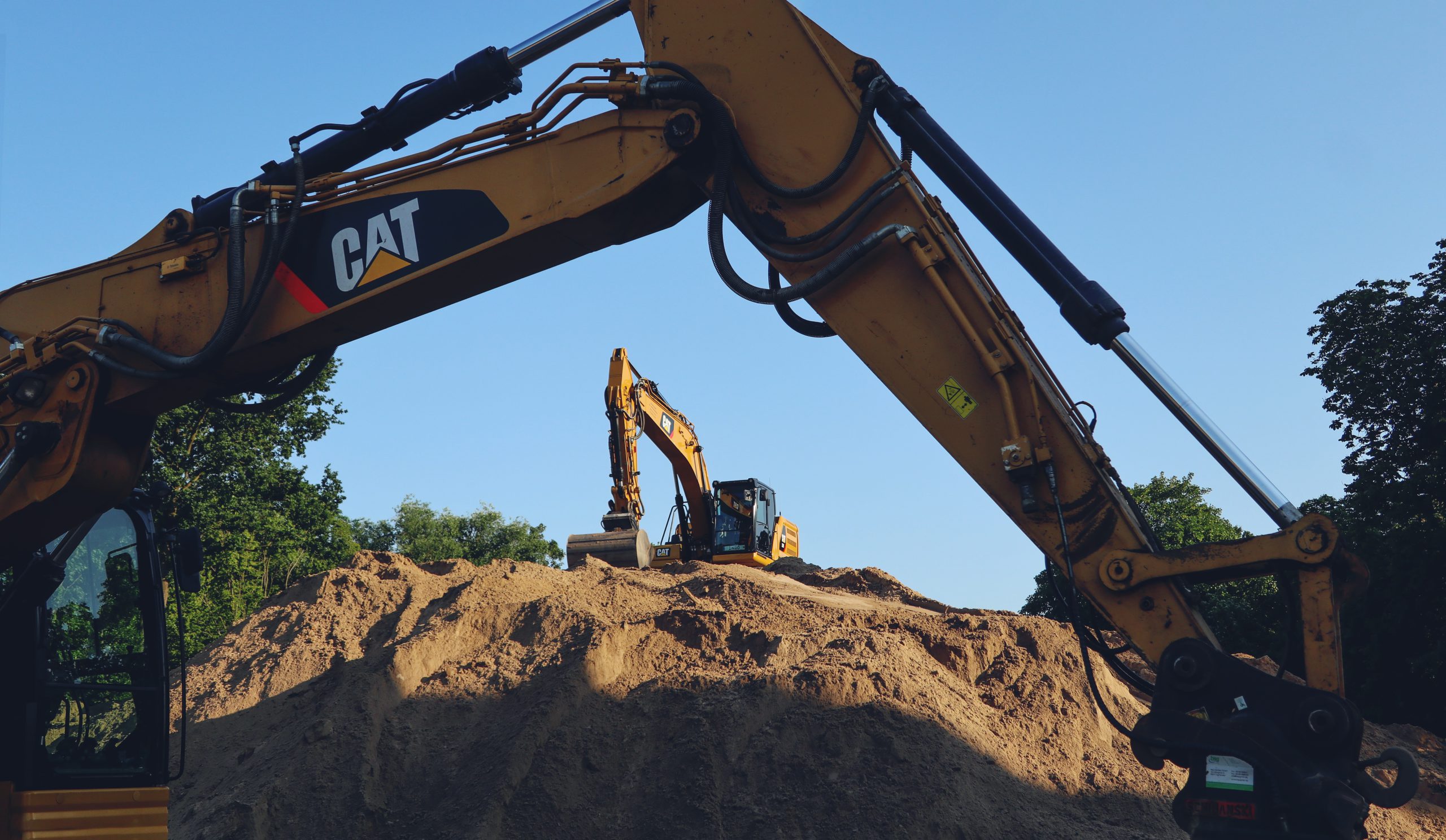 a large pile of dirt sitting next to a bulldozer